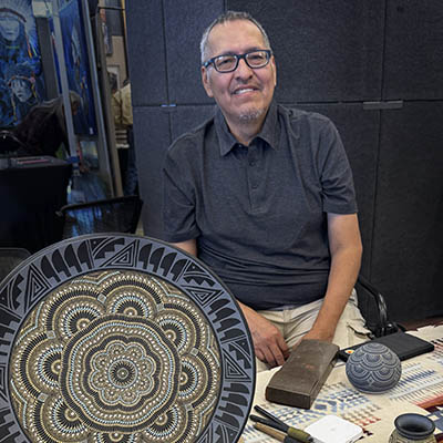 Rodney John Pottery | Rodney with hand etched pottery at show Rodney John Pottery | Hand Etched SW Pottery
